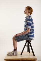 Sitting reference of whole body striped blue gray shirt blue jeans shorts black gray shoes Wesley